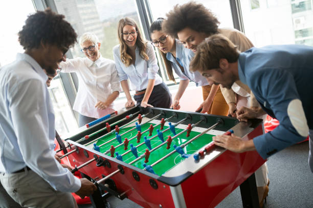 istock Multiracial people having fun in office room, excited diverse employees enjoying activity at work 1170504494