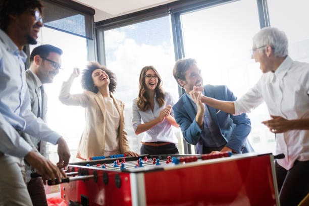istock Multicultural business people celebrating win while playing table football 1170504527