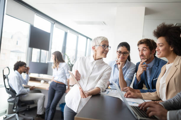 istock Group of successful business people at work in office 1170504578
