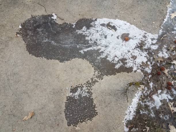 istock slippery black ice on asphalt or pavement 1170505006