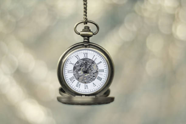 istock Gold pocket watch isolated against a bokeh background 1170505166