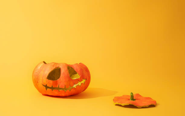 istock Pumpkin lantern on yellow background 1170505854