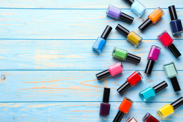 istock Nail polish bottles on blue wooden table 1170507341