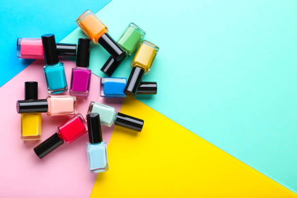 Nail polish bottles on colorful background Nail polish bottles on colorful background enamel wear stock pictures, royalty-free photos & images