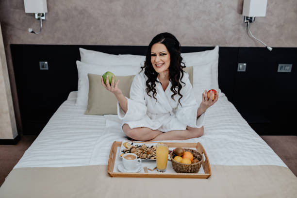 istock One woman having a breakfast in hotel room 1170508933