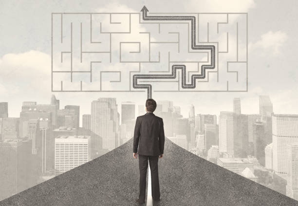 istock Businessman looking at road with maze and solution 1170509147