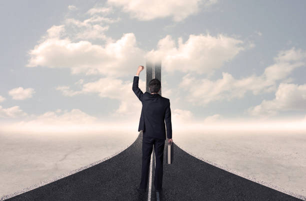 istock Businessman looking at 3d road that goes up in the sky 1170510079