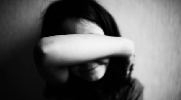 Little girl covers her face with hands isolated