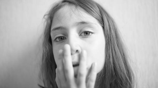 istock Little girl covers her face with hands 1170510490