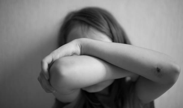 Little girl covers her face with hands Little girl covers her face with hands isolated Trafficking stock pictures, royalty-free photos & images