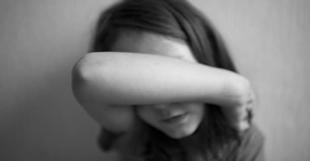 istock Little girl covers her face with hands 1170510500