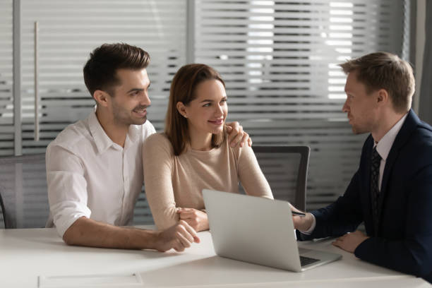 istock Happy young couple talk with baker taking mortgage 1170512617