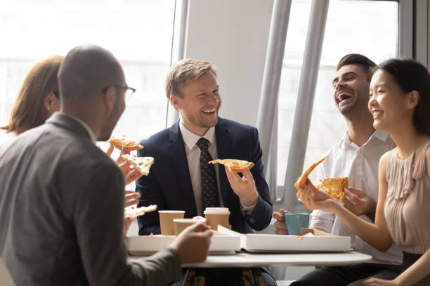 istock Happy multiethnic colleagues chat enjoying pizza in office 1170512710