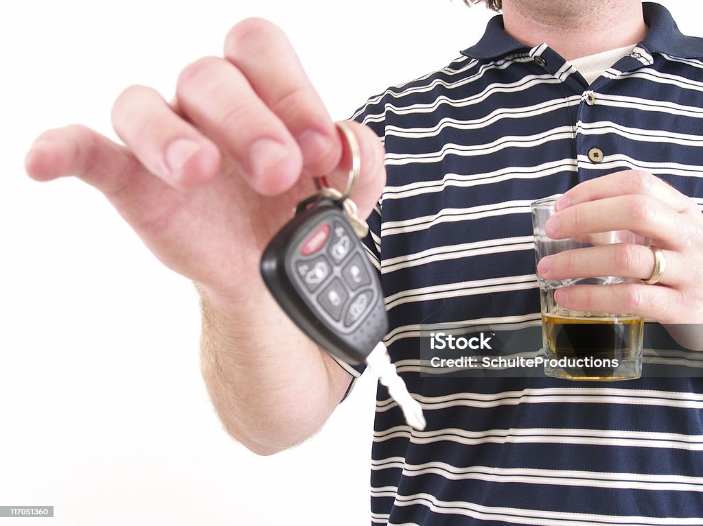 Drinking and Driving a man handing over his keys while drinking a beer. Alcohol Abuse Stock Photo