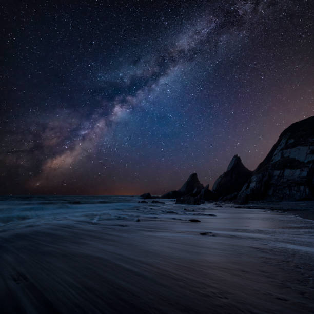 istock Stunning composite landscape image of Mily Way core over sea rocks and cliffs with long exposure tide on beach 1170514235