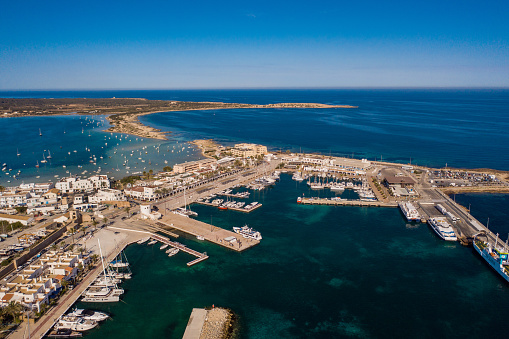 Beautiful turquoise bay at Formentera, aerial view. Snow-white yachts near the coast.