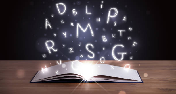 istock Open book with glowing letters flying out 1170516547