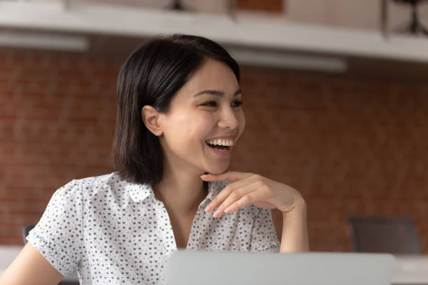 istock Smiling female employee laugh talking with colleague 1170516625