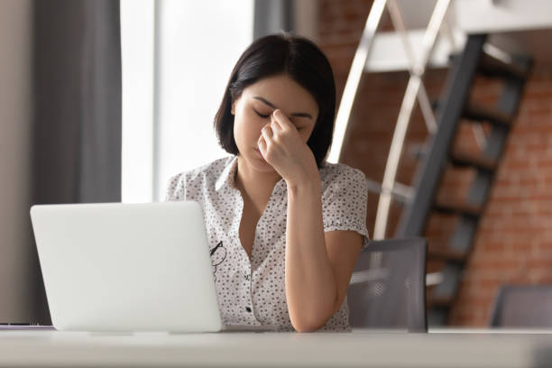 istock Tired woman massage eyes suffering from headache 1170516630