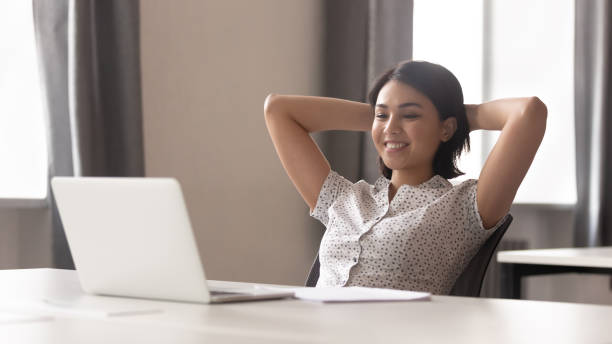istock Smiling woman worker relax in chair at workplace 1170516634