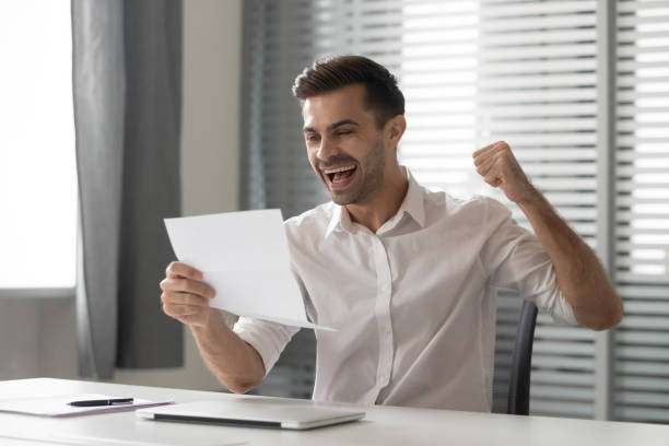 istock Overjoyed male employee feel euphoric reading pleasant letter 1170516685