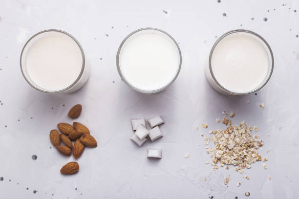 istock Vegan milk from coconut, oatmeal and almonds on a gray table 1170517312