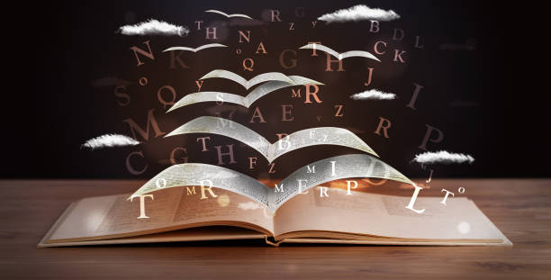 istock Pages and glowing letters flying out of a book 1170517569