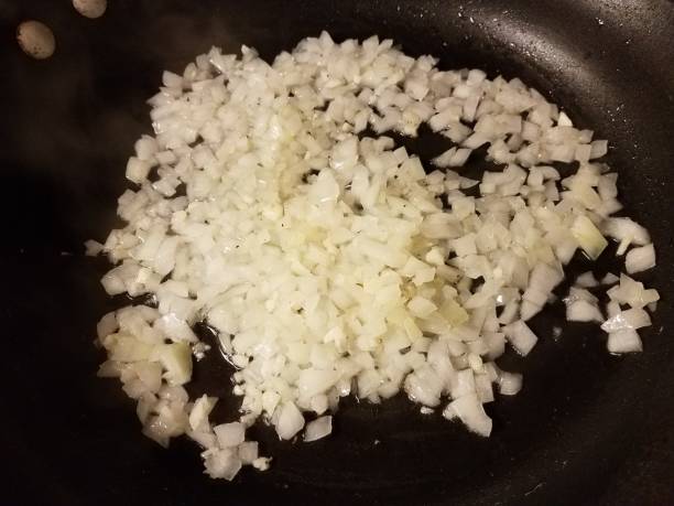 istock onions and garlic cooking in frying pan 1170517893