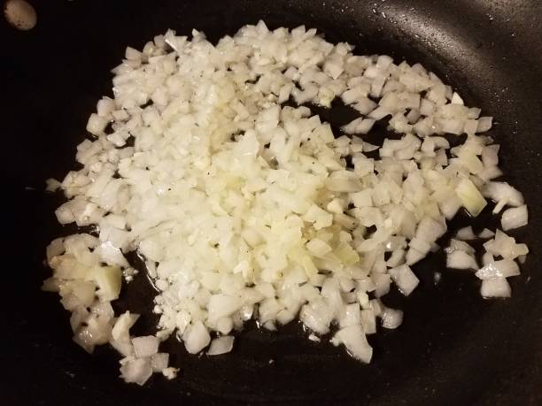 istock onions and garlic cooking in frying pan 1170517896