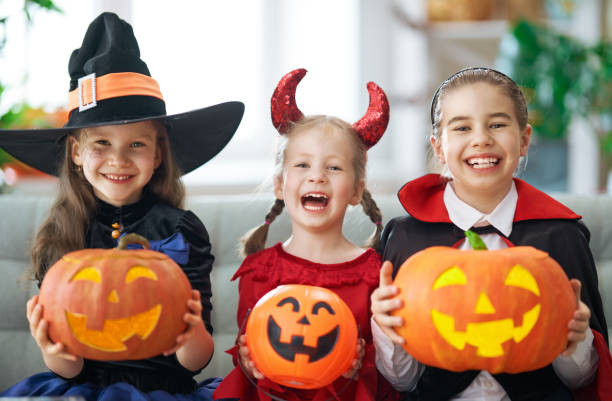 istock kids with carving pumpkin 1170519205