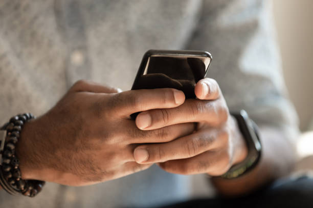 istock African man holding cellphone using applications, close up view 1170519312
