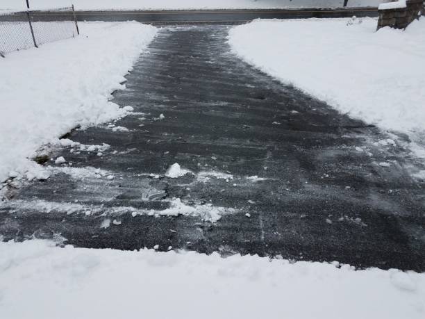 istock asphalt driveway with white snow shoveling in winter 1170519522