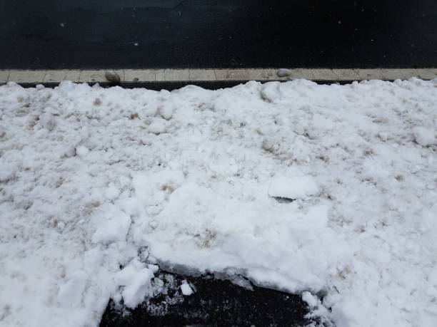 istock white snow and asphalt road with white line 1170519555