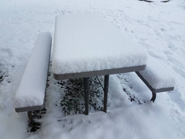 istock half a foot of snow on picnic table 1170521649