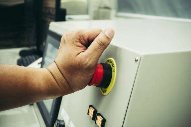 männlicher bediener verwenden linke hand, um nottaste zu drücken, um die maschine zu stoppen, während unfall auftreten - push button off stock-fotos und bilder