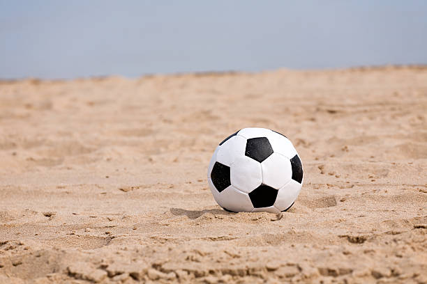 istock soccer ball on beach 117052331