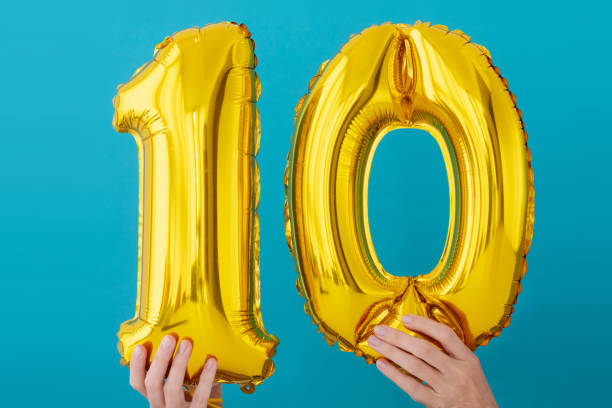 Gold foil number 10 ten celebration balloon Gold foil number 10 ten celebration balloon on a blue background 10 balloon stock pictures, royalty-free photos & images