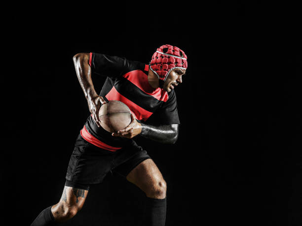 istock One caucasian man playing rugby on black background in mixed light 1170525901