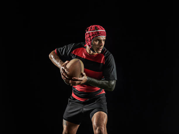 istock One caucasian man playing rugby on black background in mixed light 1170525917