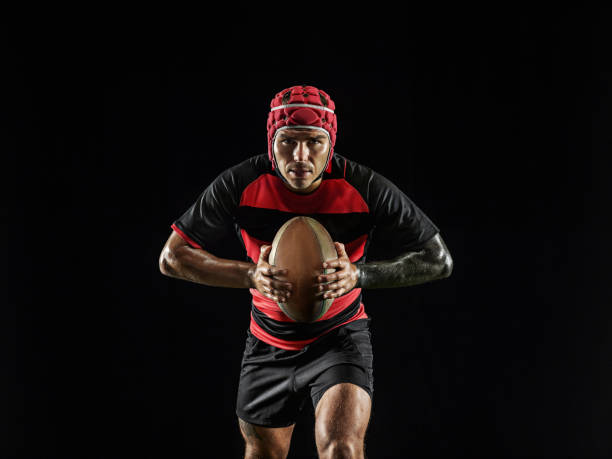istock One caucasian man playing rugby on black background in mixed light 1170526034