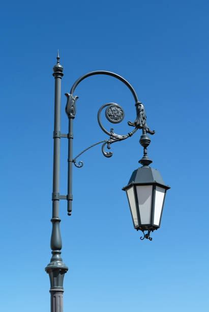 istock Old metal streetlight on blue sky background 1170527409