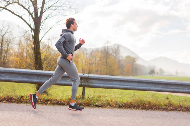 istock Young man jogging on autumn day 1170528336