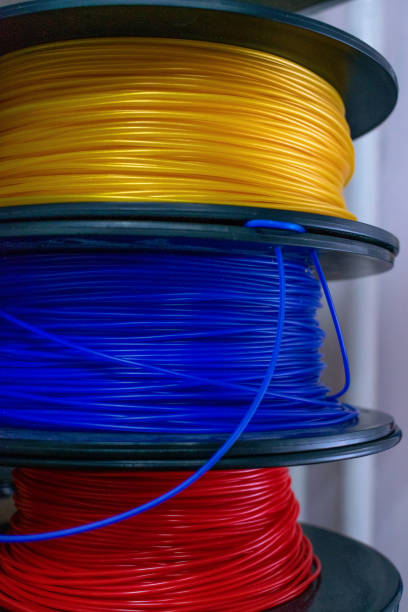 istock 3D printing material, ABS filament, PLA (Polylactic Acid),  PVA Filament.  Colored polymer in coils on the shelves. 1170528848
