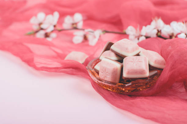 istock Pink chocolate bar and white flower on pink and red background. Ruby new chocolate. New pink sweet dessert. 1170528885