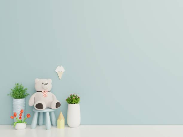 istock Teddy bear in the children's room on blue wall background. 1170529107