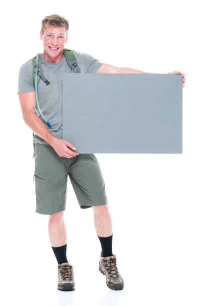 istock Friendly male hiker is holding a grey placard sign 1170530668