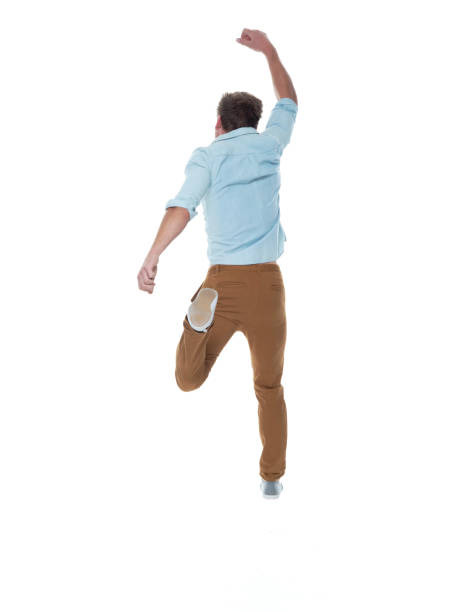 istock Casual well dressed man jumping 1170532096