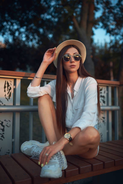 istock Beautiful brunette in a hat and sunglasses 1170532127