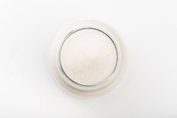 istock Sugar in  glass bowl on white background  top view- Image 1170534373