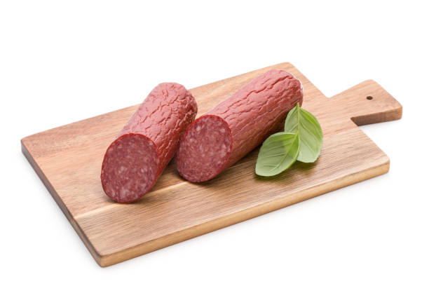 istock Salami smoked sausage, basil leaves on white background cutout. 1170534729